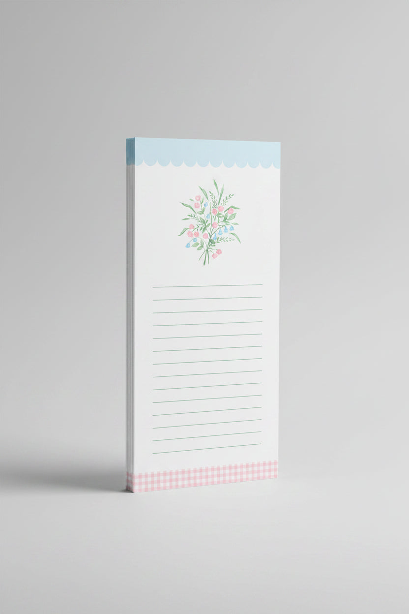 Notepad with floral design and checkered footer on a light gray background