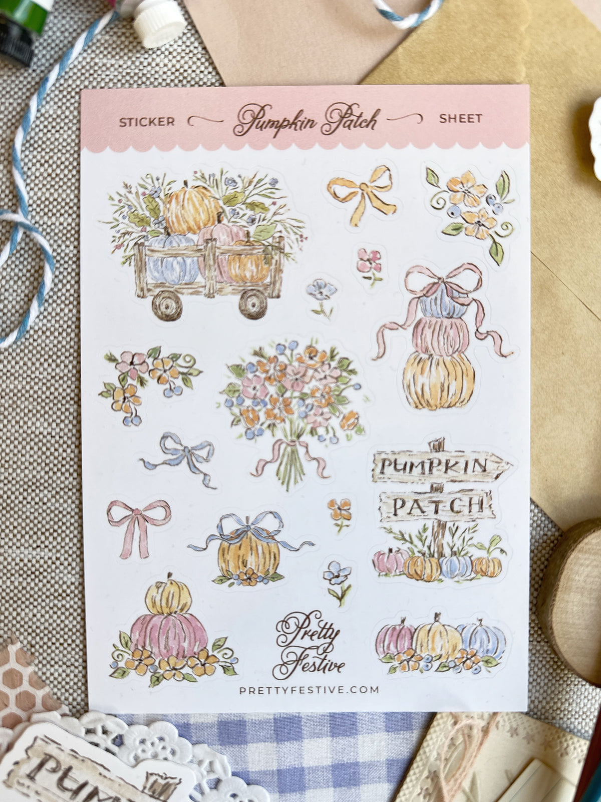 A sheet of decorative stickers from Pumpkin Patch by Pretty Festive, featuring watercolor-style illustrations of pumpkins, flowers, bows, and signs, displayed on a styled flat-lay background.