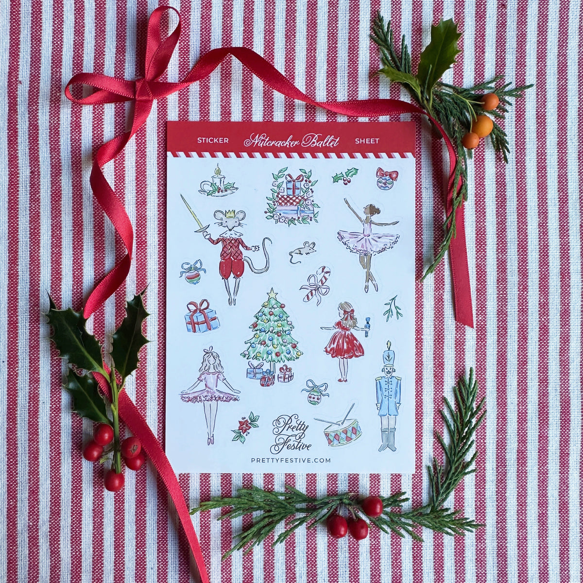 A6 Sticker Sheet caption Nutcracker Ballet featuring several Christmas Nutcracker Ballet themed illustrations. Background is red and white striped fabric, red ribbon and foliage and berries
